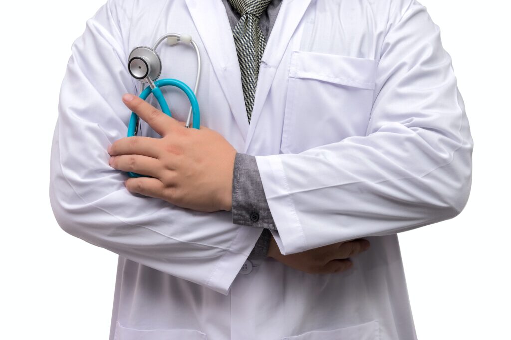 Doctor standing arms crossed with stethoscope isolated on white background