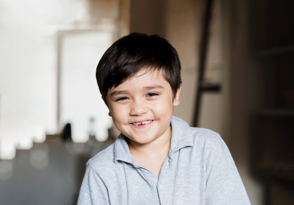 Happy kid looking at camera with smiling face, Portrait healthy child relaxing at home,